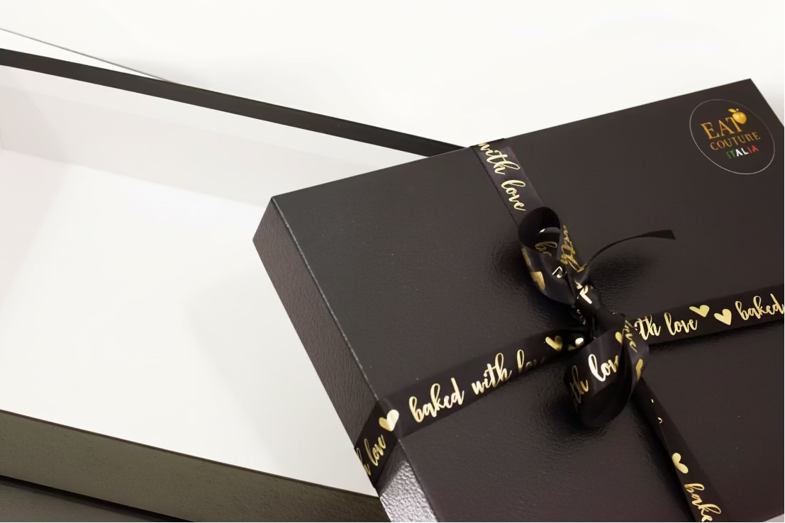 empty box black ribbon and 'baked with love' text.