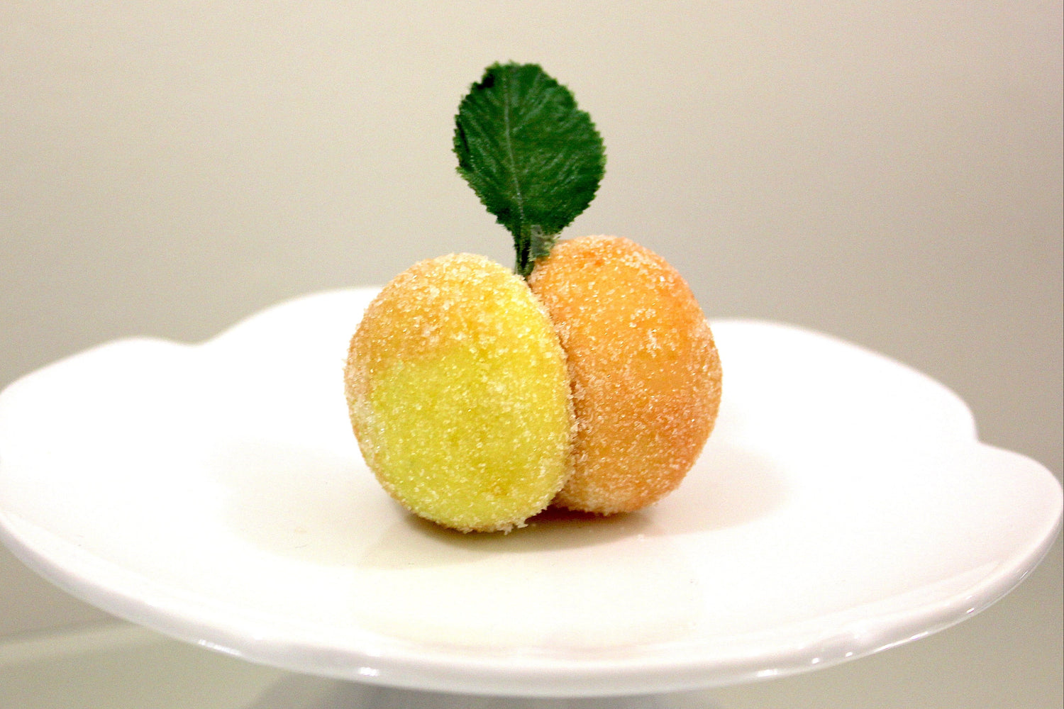 an original flavour, italian peach cookiie, sugared fruits on a white plate with a plain background