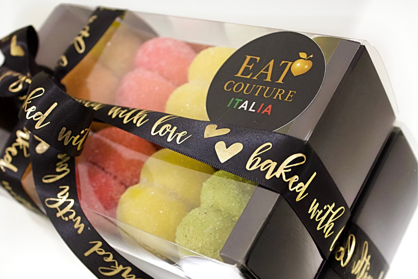Packaged cookies with a decorative ribbon and 'Eat Couture Italia' label on a white background